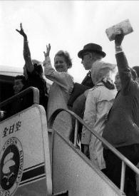 Portada:Plano general de Aniela Rubinstein, Arthur Rubinstein y Alina Rubinstein despidiendose en las escalerillas de un avión entre otras personas.