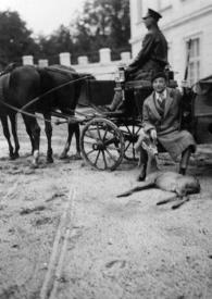 Portada:Plano general de un coche de caballos, el cochero sentado y Paul Kochanski mostrando el resultado de la caza, un ciervo