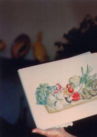 Portada:Plano medio Aniela Rubinstein mostrando un cuadro que representa un bodegón, pintado por ella